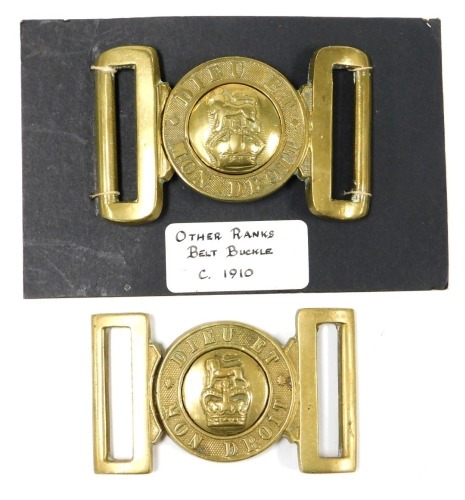 Two British Army brass belt buckles, each inscribed Dieu et Mon Droit, with central crown and lion surmount boss.