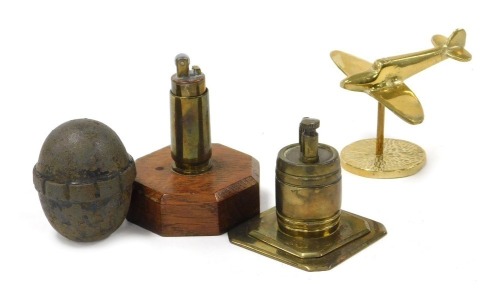 Two trench craft brass lighters, steel pommel and a post war brass model Spitfire.