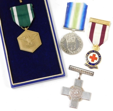 A US Navy Military Commendation medal, etc., including a Queen Elizabeth South Atlantic medal replica, British Red Cross Society Service medal, and a replica Military Cross.