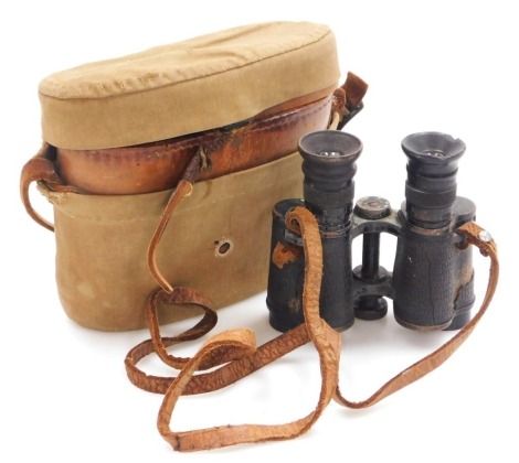 A pair of WWI period binoculars, War Department arrow marks, numbered 26166, in leather case with khaki canvas outer case, the inner lid marked Bausch & Lomb Optical Co Rochester NY.