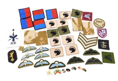 A collection of military cloth badges and insignia, modern examples including Desert Rat and Parachute cloth badges, etc.