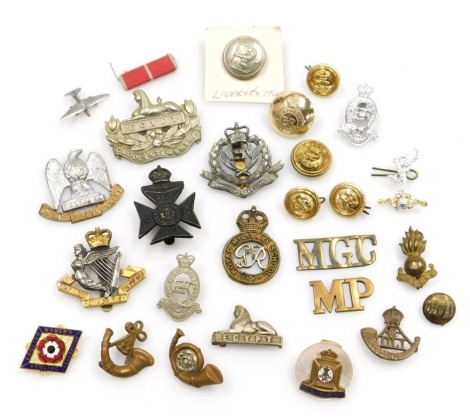 A small assortment of military cap badges and buttons, including some railway and livery buttons.