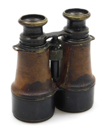 A pair of WWI field binoculars, with crow foot arrow marking, the eye pieces inscribed L Petit Paris, with leather grips.