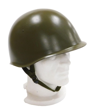 A Czechoslovakian Army steel helmet, circa 1960 with inner leather liner and chin strap.