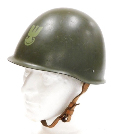 A Polish Army steel helmet, circa 1960, with inner leather liner and chin strap.