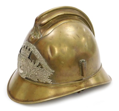 An early 20thC French fireman's brass helmet, with plaque crest inscribed Sapeurs Pompiers, Usine St Epin.