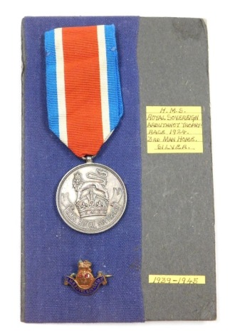 An HMS Royal Sovereign Arbuthnot Trophy Race 1924 silver medal, inscribed Arbuthnot Trophy Race 1924 Third Man Home, Birmingham 1924 and maker's mark for Paige Keen and Paige, and a lapel badge for HMS Royal Sovereign.