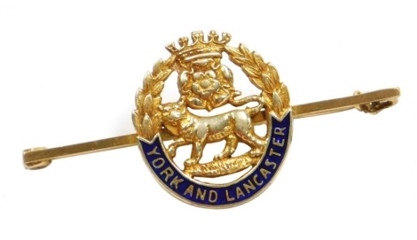 A regimental sweetheart brooch for the Yorks and Lancashire Regiment, enamelled yellow metal, with hinged pin, stamped 9ct, 5.1g all in.