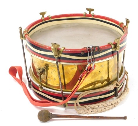 A military snare drum by Henry Potter and Co, with brass frame and fittings, painted striped banding and with strap and single stick, the brass case stamped Henry Potter and Co makers 36-38 West Street Charring Cross Road, London, 38cm diameter.