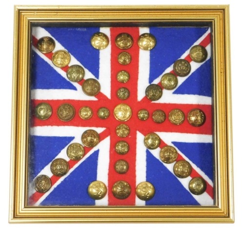 Various British Army regimental brass buttons, mounted on Union Jack felt flag backing, framed and glazed.