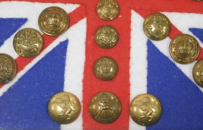 Various British Army regimental brass buttons, mounted on Union Jack felt flag backing, framed and glazed. - 2