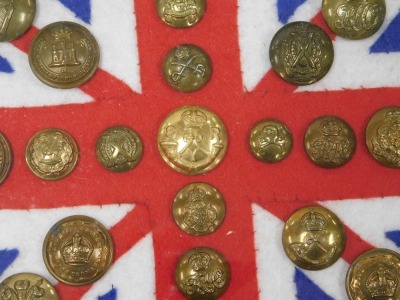 Various British Army regimental brass buttons, mounted on Union Jack felt flag backing, framed and glazed. - 3