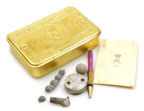 A WWI Princess Mary brass gift tin, Christmas 1914, with original greetings booklet, and some lead shrapnel, a musket ball and pencil, etc.