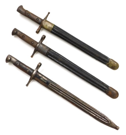 Three Italian bayonets marked Terni, with serial number (indistinct), the other stamped CCA 1942, both with leather scabbards, and another with steel scabbard.