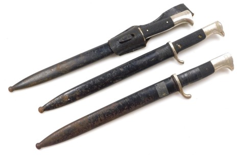 Three German WWII dress bayonets, one signed Siegfried Waffen, E Pack Solingen, with steel scabbard, another Carl Eickhorn, Solingen (AF), and one indistinctly signed, with leather frog and all with steel scabbards.