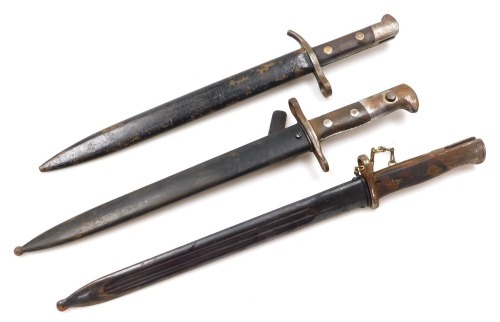 Three Mauser bayonets, one Spanish version with 4.5cm blade marked Toledo crowned monogram FN numbered 343L to the reverse, with steel scabbard, another with 30cm blade stamped Hackman & Co, with steel scabbard, and another Swiss version bayonet with 29.5