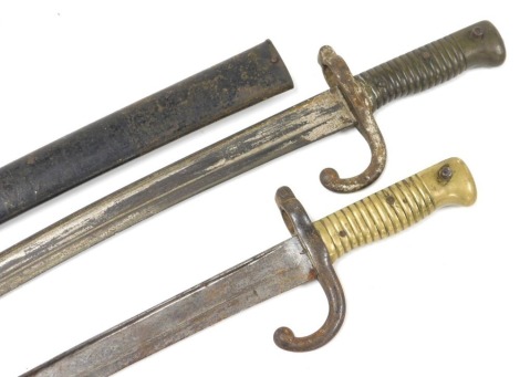 A French M1866 pattern Chassepot bayonet, with Yataghan blade, blade 57cm long, engraved back indistinctive, with steel scabbard, similar bayonet, lacking scabbard (2)