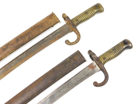 A French M1866 pattern Chassepot bayonet, with Yataghan blade, 57cm long, inscribed to the back 1873, with steel scabbard, number 89808, another bayonet with no engraving to the blade back, number 80724 to the steel scabbard. (2)