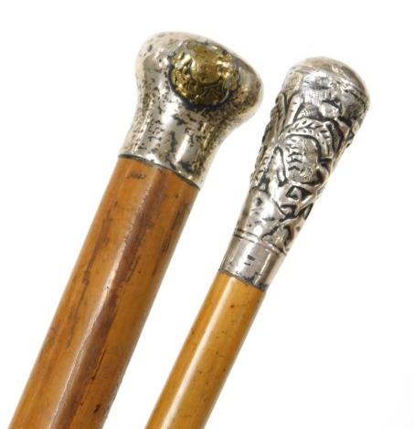 A malacca swagger stick with white metal terminal and Royal Flying Corps crest, another malacca long slender swagger stick with white metal terminal, (2).