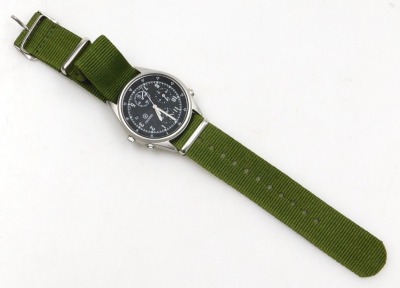 A Seiko British military chronograph watch, in stainless steel case with black dial, three subsidiary hands and date, with luminous Arabic numerals and hands, the case back numbered 6645-99 8149181 with broad arrow above 1187/93, serial number 696309, and - 2