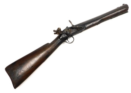 An 18thC flintlock blunderbuss, the lock plate indistinctly stamped Theo Richards, the 35cm barrel with fore and rear sights, ramrod and walnut stock, engraved brass trigger guard with acorn terminal, 75cm overall.