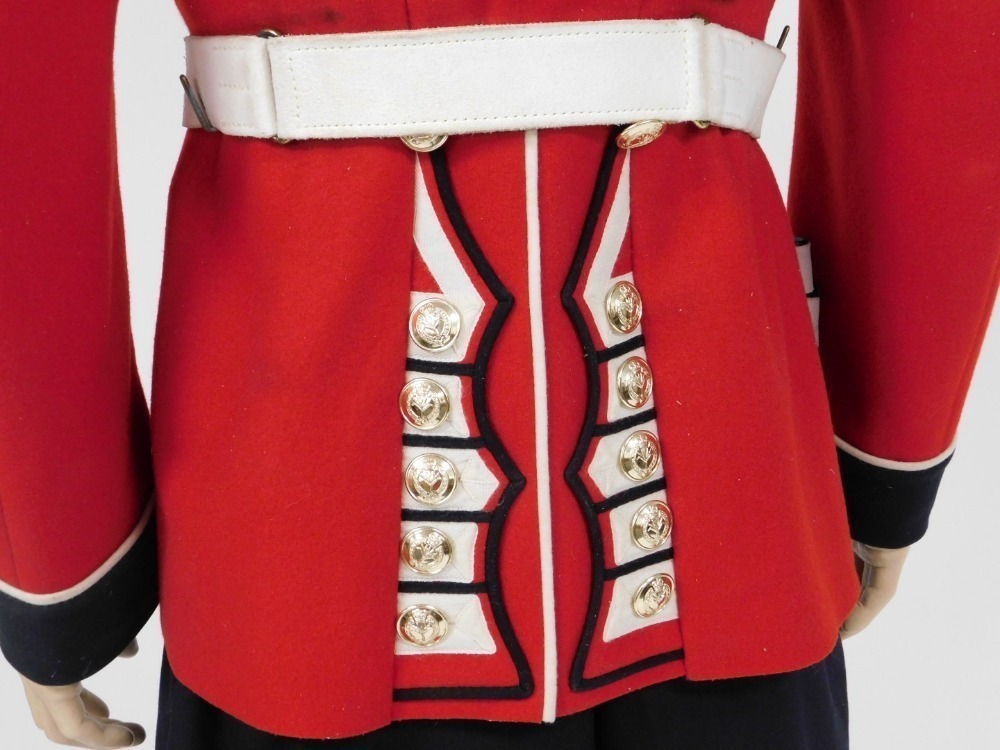 A Welsh Guards dress uniform, comprising red dress tunic, with white  leather belt and bayonet scabbard,