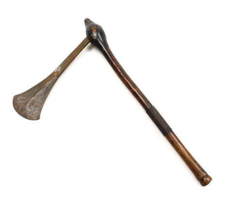 An African tribal war axe, possible a Chokwe, with steel blade 29cm, and natural tapered wooden shaft with turned terminal and iron banded grip, 57cm.