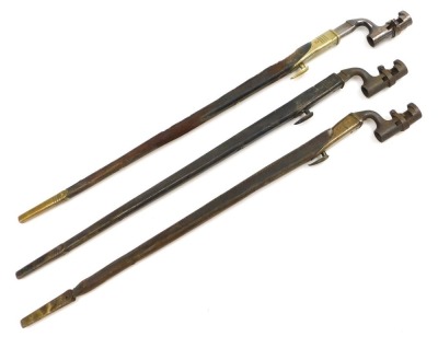 Three British 1876 pattern socket bayonets, two Martini Henry and one Enfield bayonet, each with War Department arrows and other marks, each with 54cm blades.