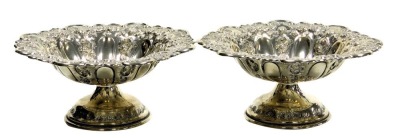 A pair of Edward VII silver sweetmeat dishes, of pedestal form, embossed with fruit, flowers and scrolling leaves, Charles Horner, Birmingham 1901, 13.91oz.