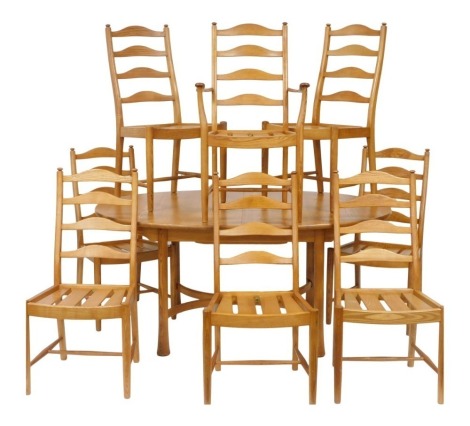 An Ercol light elm draw leaf dining table, raised on turned out swept legs, 74cm high, 162cm wide, 212cm extended, 107.5cm deep, together with eight ladder back dining chairs, comprising a carver and seven single chairs.