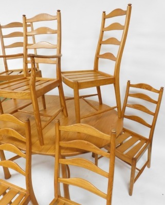 An Ercol light elm draw leaf dining table, raised on turned out swept legs, 74cm high, 162cm wide, 212cm extended, 107.5cm deep, together with eight ladder back dining chairs, comprising a carver and seven single chairs. - 2