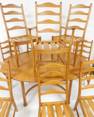 An Ercol light elm draw leaf dining table, raised on turned out swept legs, 74cm high, 162cm wide, 212cm extended, 107.5cm deep, together with eight ladder back dining chairs, comprising a carver and seven single chairs. - 4