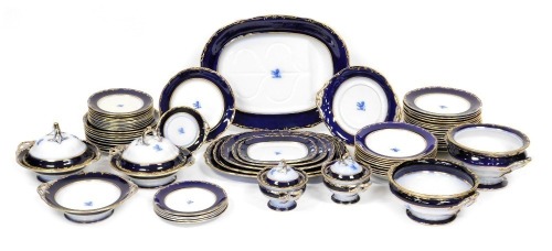 A late 19thC Davenport pottery dinner service, each bearing a crest, within a cobalt blue border, gilt heightened, bears registration mark, impressed and printed marks, comprising six graduated meat platters, soup tureen, three vegetable tureens, and two