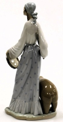 A Lladro porcelain figure of a lady, modelled standing with a stick and tambourine, alongside a bear, printed and impressed marks, 37cm high. - 2