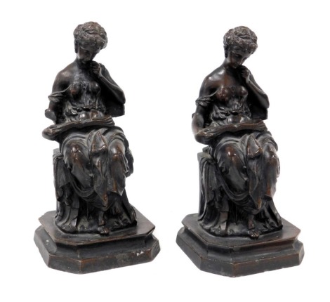 A pair of bronzed plaster bookends, modelled as classical ladies seated reading a book, raised on a canted square base, 27cm high. (AF)