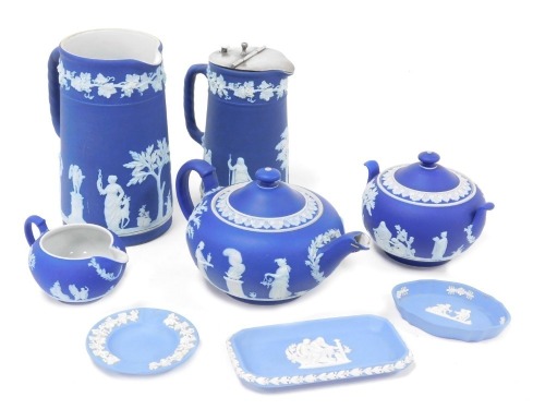 A group of Wedgwood dark and light blue Jasperware, including a tea pot, sucrier and cream jug, and a covered water jug. (qty)