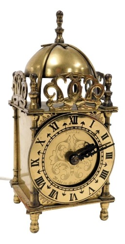 A 20thC Smiths brass lantern clock, chapter ring bearing Roman numerals, with electric movement, 18cm high.