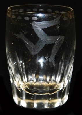 An early 20thC cut glass shot glass, etched with Triskelion of the Isle of Mann, in cylindrical container, decorated to the lid with "Just a Nip", 5cm high. - 2