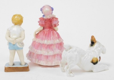 A Royal Doulton figure modelled as Ruby HN1724, Royal Worcester figure modelled as Tommy 2913, and Royal Doulton of a terrier playing with a ball HN1103. (3) - 2