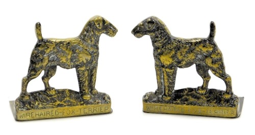 A pair of early 20thC brass bookends, cast as wire haired fox terriers, 12cm wide.