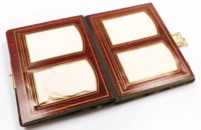 A Victorian portrait photograph album, with metal clasps, the front with a framed oval bevelled glass mirror, on a strut stand, with frieze drawer, stand 30cm high. - 2