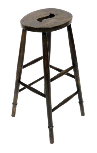 A Millbuffet elm warehouse high clerk's stool, raised on turned legs, united by turned stretchers, 76cm high.