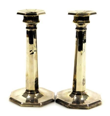 A pair of George V loaded silver candlesticks, of octagonal form, Birmingham 1915, 18.10oz all in, 18cm high.