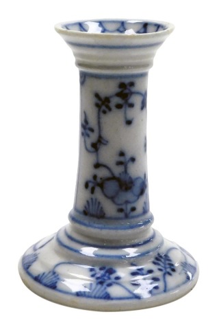 An early 20thC blue and white pottery candlestick, with floral decoration, 11.5cm high. (AF)