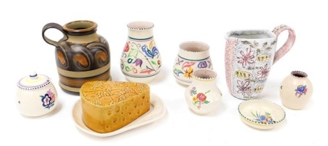 A group of Poole pottery, traditionally decorated with flowers, including vases, and a preserve pot and cover, together with a Denby stoneware jug, painted with flowers, further jug, and a pottery cheese dish and cover, moulded with fruit. (9)