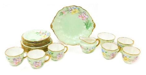 A Royal Crown Derby porcelain part tea service, outside painted with flowers, printed, and artist's painted marks, comprising cream jug, sugar bowl, bread plate, six tea cups, saucers and tea plates.