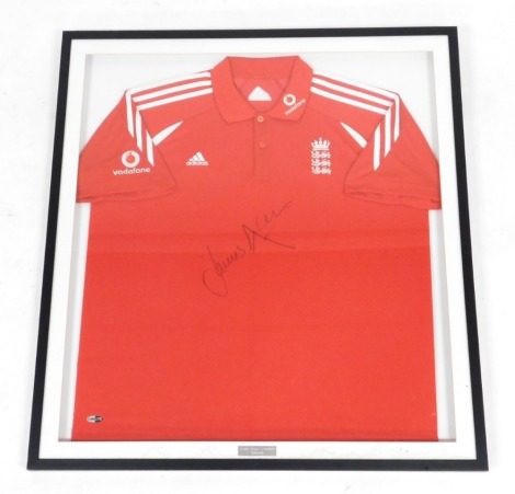 An England red cricket shirt, signed by James "Jimmy" Anderson, 5th September 2008, framed and glazed, 85cm x 77cm.