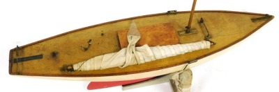 An early 20thC wooden pond yacht, with a cream and red painted hull, with rigging and sails, 90cm wide. - 3