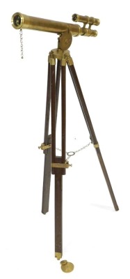 A brass telescope, with a tripod stand.