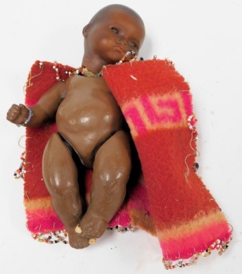 An Armand Marseilles bisque head black doll, model 341 12/0K, with a Zulu fabric and beadwork applied tunic, 21.5cm high. - 2